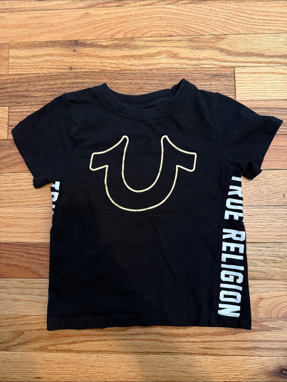 True Religion Black Tee with Gold Outline Logo and Side Text